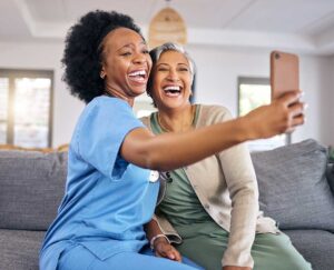 Caregiver and older adult reviewing a care plan in a bright assisted living common room.